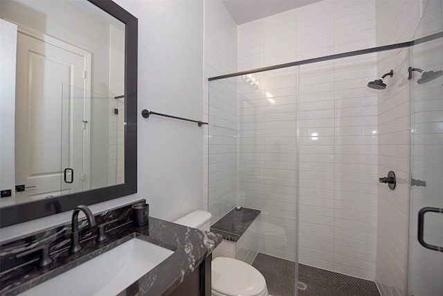 bathroom featuring walk in shower, vanity, and toilet