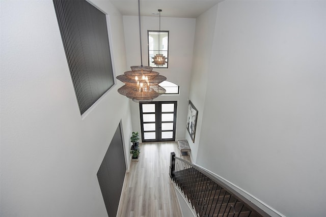 foyer featuring light wood-type flooring and french doors