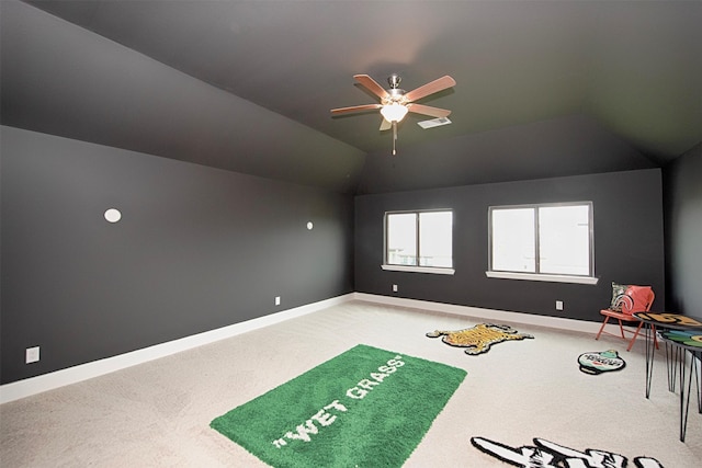 interior space featuring carpet flooring, vaulted ceiling, and ceiling fan