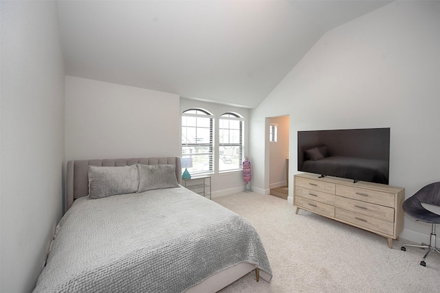 bedroom featuring light carpet and vaulted ceiling