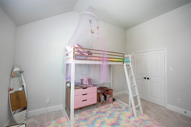 carpeted bedroom featuring lofted ceiling