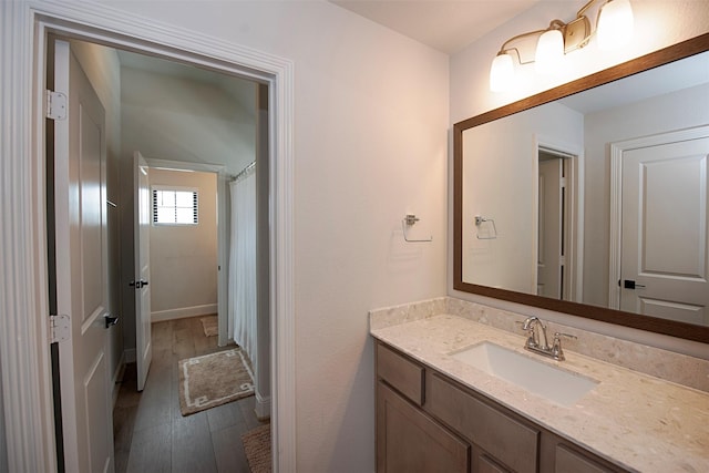 bathroom featuring hardwood / wood-style flooring and vanity