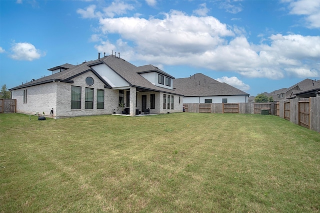 rear view of house with a yard