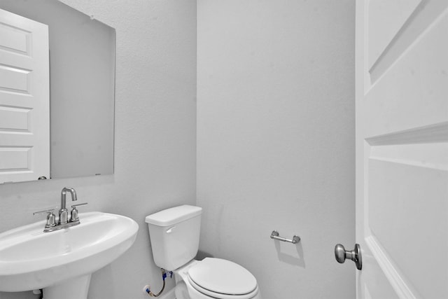 bathroom featuring sink and toilet