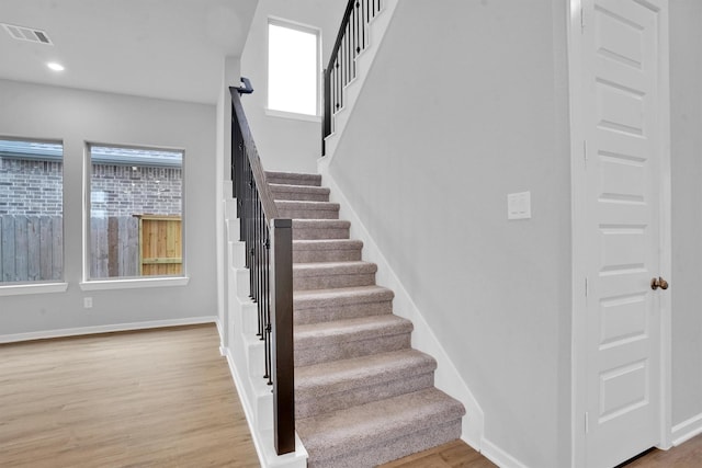 staircase featuring hardwood / wood-style floors