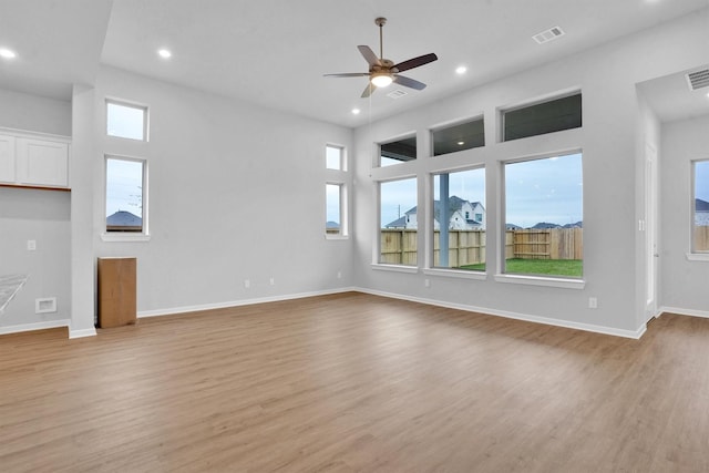 unfurnished living room with ceiling fan and light hardwood / wood-style flooring