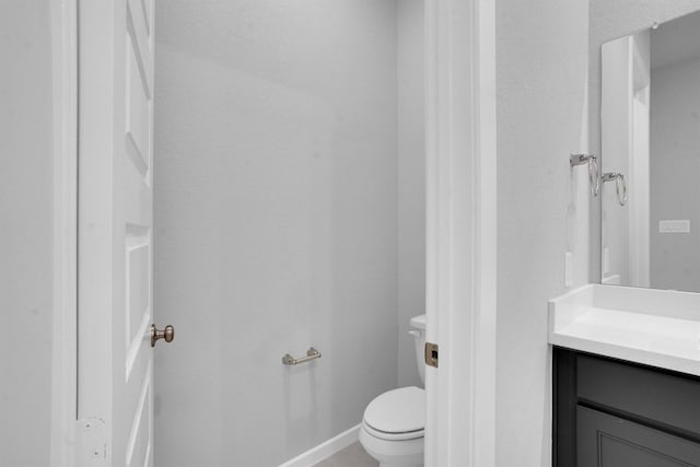 bathroom with tile patterned flooring, vanity, and toilet