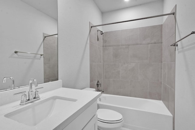 full bathroom featuring toilet, vanity, and tiled shower / bath