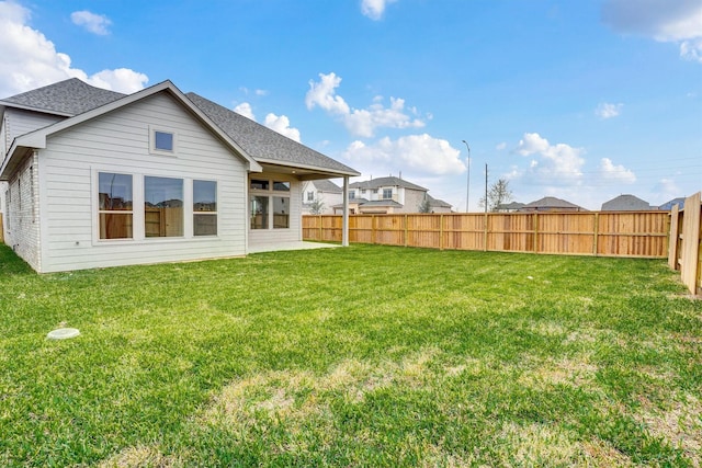 back of property featuring a lawn