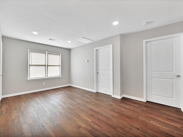 empty room with dark wood-type flooring