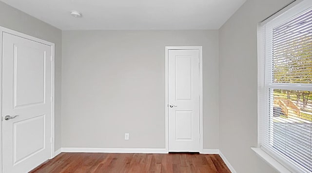 unfurnished room with dark wood-type flooring