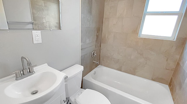 full bathroom featuring vanity, toilet, and tiled shower / bath