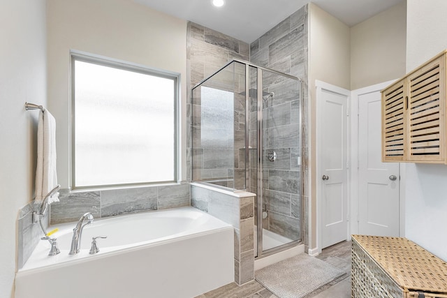 bathroom featuring hardwood / wood-style floors and separate shower and tub