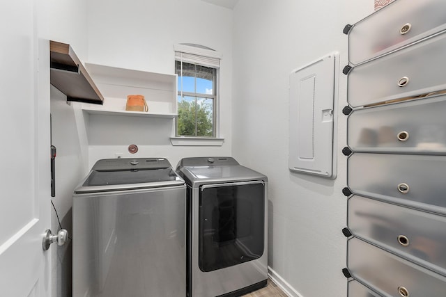 washroom featuring electric panel and washer and dryer