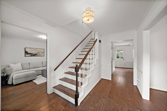 stairs featuring hardwood / wood-style floors and ornamental molding