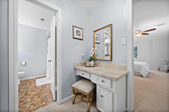 bathroom with vanity, toilet, and ceiling fan