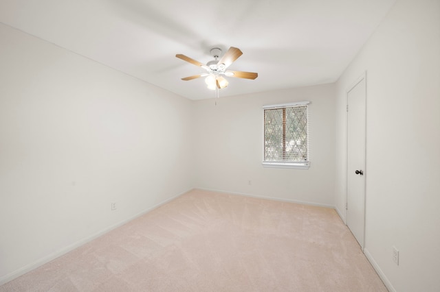 unfurnished room with ceiling fan and light carpet