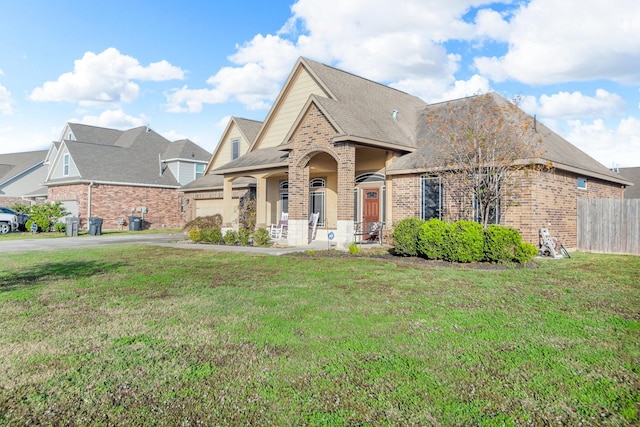 view of front of home with covered porch and a front lawn