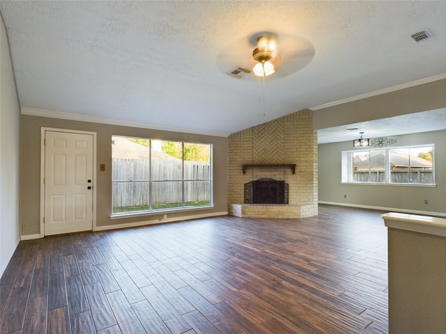 unfurnished living room featuring ceiling fan, a fireplace, dark wood-type flooring, and a textured ceiling