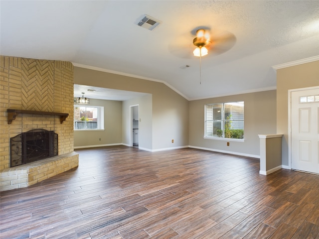 unfurnished living room with a textured ceiling, dark wood-type flooring, a healthy amount of sunlight, and ceiling fan with notable chandelier