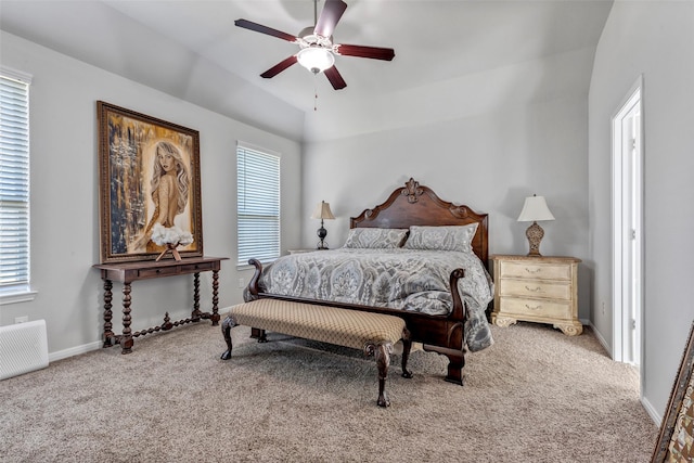 bedroom with multiple windows, ceiling fan, carpet, and lofted ceiling