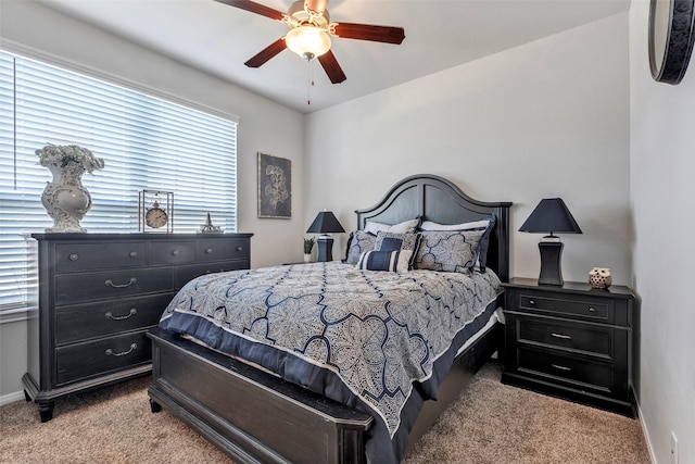 bedroom with ceiling fan and light colored carpet