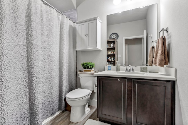 bathroom featuring hardwood / wood-style floors, vanity, and toilet