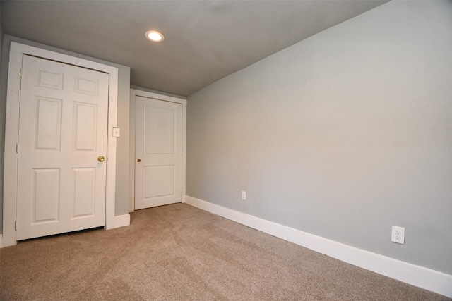 unfurnished bedroom with light carpet