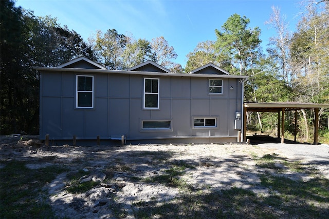 rear view of house featuring a carport