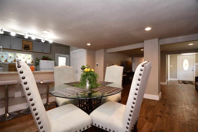 dining space featuring dark hardwood / wood-style floors