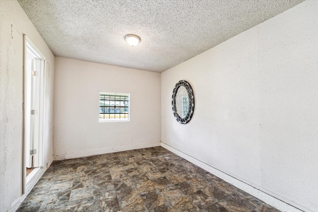 unfurnished room featuring a textured ceiling