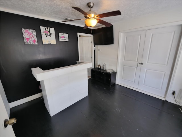 office area with ceiling fan and a textured ceiling