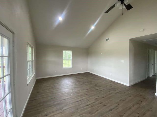 spare room featuring dark hardwood / wood-style flooring, high vaulted ceiling, and ceiling fan