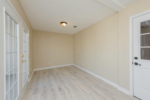 unfurnished room with light hardwood / wood-style flooring