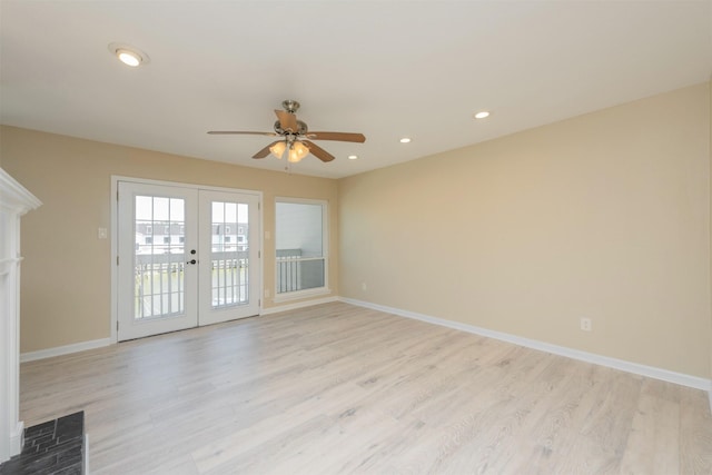 spare room featuring french doors, light hardwood / wood-style floors, and ceiling fan