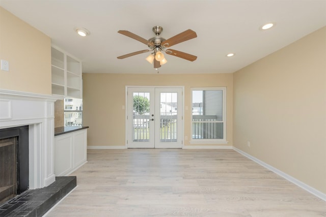 unfurnished living room featuring french doors, light hardwood / wood-style floors, and ceiling fan