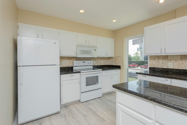 kitchen featuring tasteful backsplash, white cabinets, light hardwood / wood-style floors, and white appliances