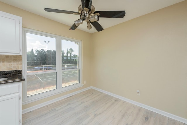 unfurnished dining area with ceiling fan and light hardwood / wood-style flooring