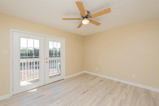 spare room featuring a textured ceiling, ceiling fan, light hardwood / wood-style flooring, and french doors