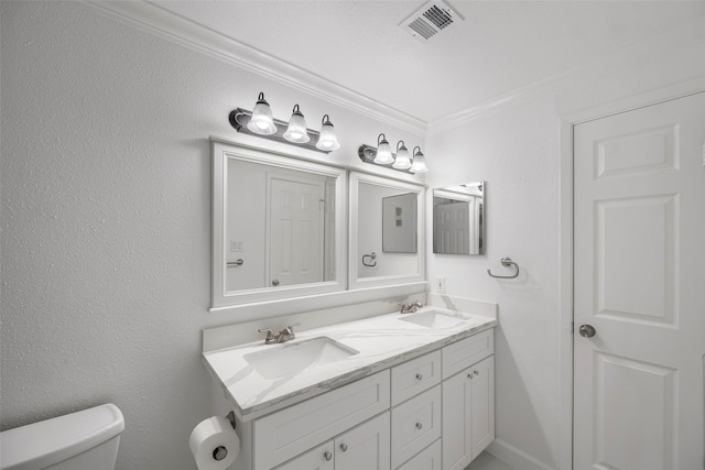 bathroom with vanity, toilet, and ornamental molding