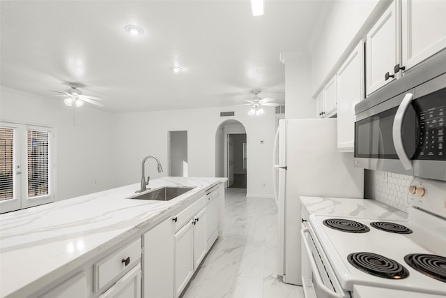 kitchen featuring white cabinetry, french doors, sink, light stone countertops, and white appliances