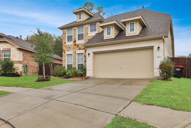 view of front of house featuring a garage and a front lawn