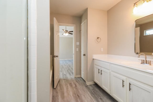 bathroom with hardwood / wood-style floors, vanity, and ceiling fan