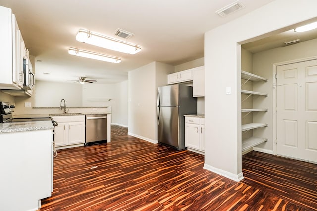 kitchen featuring white cabinetry, ceiling fan, sink, stainless steel appliances, and dark hardwood / wood-style flooring