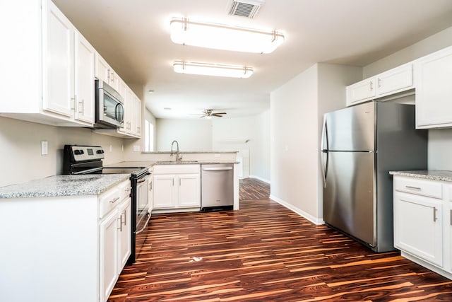 kitchen featuring white cabinets, appliances with stainless steel finishes, dark hardwood / wood-style floors, and ceiling fan