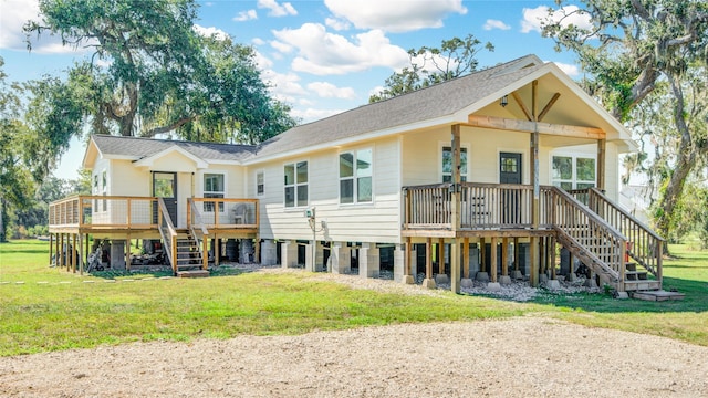 back of property with a yard and a wooden deck