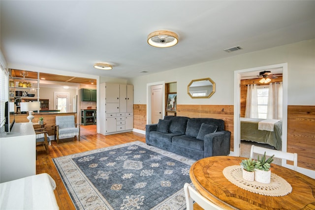 living room with hardwood / wood-style floors and ceiling fan