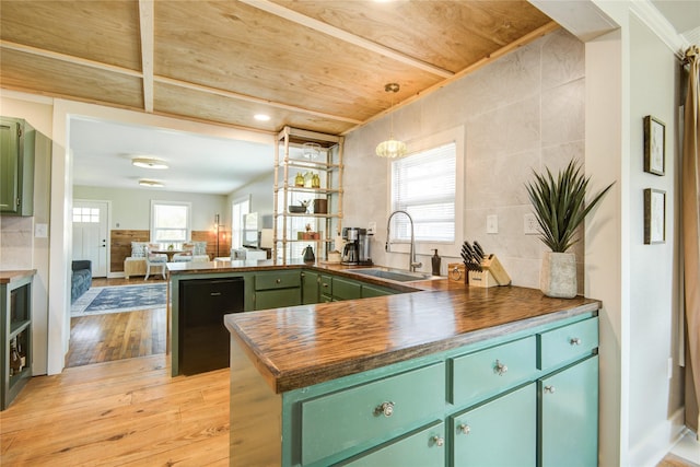 kitchen with light hardwood / wood-style floors, plenty of natural light, green cabinets, and kitchen peninsula