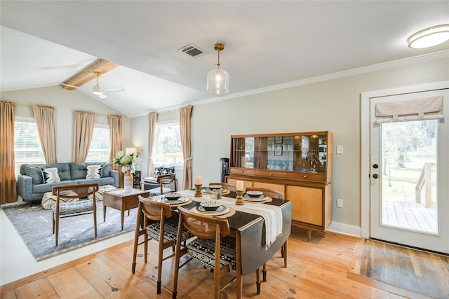 dining room featuring lofted ceiling with beams, light hardwood / wood-style floors, ceiling fan, and crown molding