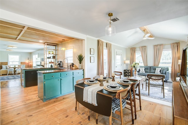 dining area with lofted ceiling with beams, light hardwood / wood-style floors, sink, and ceiling fan